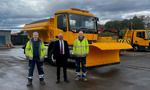 Councillor McBride stands with two members of the roads team in front of gritter