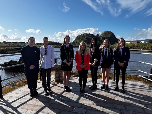 Pupils from Kilpatrick, Clydebank High and St Peter of the Apostle High School stands with Councillor Claire Steel