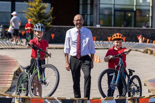 Councillor David McBride with 2 young people and their bikes